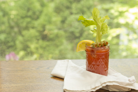 Bloody Mary vodka cocktail made at home sitting on counter by windowの写真素材