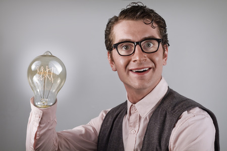 Nerdy four eyed businessman is happy about his new ideaの写真素材