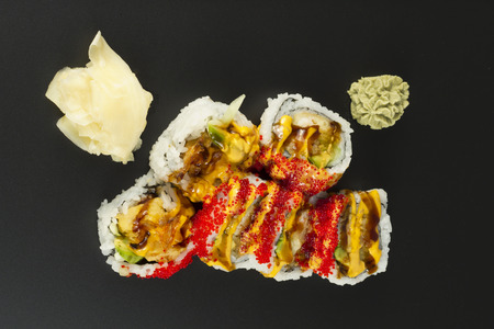 Beautiful fresh shrimp tempura sushi roll with tobiko and spicy mayonnaiseの写真素材