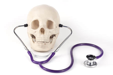 Educational medical supply skull wearing stethoscopeの写真素材