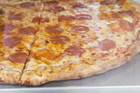 Crispy restaurant style NY pepperoni pizza pie on displayの写真素材