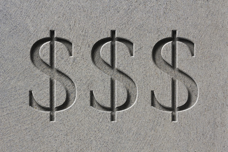 Engraving of the sign for dollars on textured old rough surfaceの写真素材