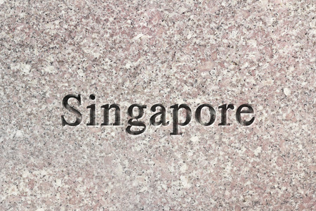 Engraving spelling the city Singapore on textured old surfaceの写真素材