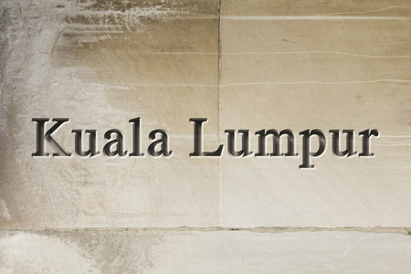 Engraving spelling the city Kuala Lumpur on textured old surfaceの写真素材