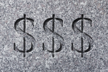 Engraving of the sign for dollars on textured old rough surfaceの写真素材