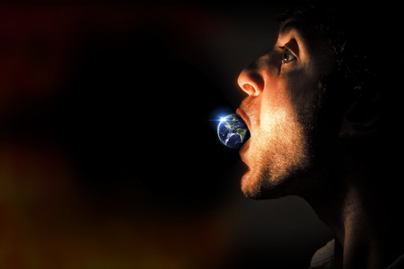 Man eating planet earthの写真素材