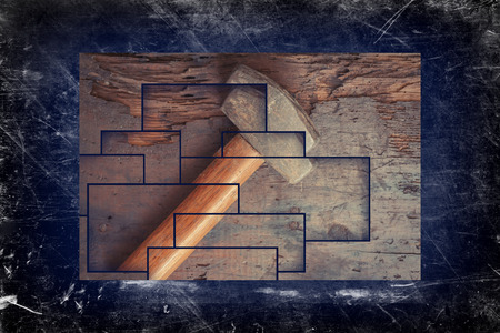 Small single handed worn sledge hammer on grunge wood backgroundの写真素材