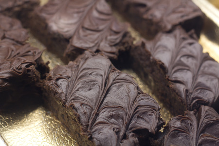 Platter of chocolate brownies with decorative icing arranged in displayの写真素材