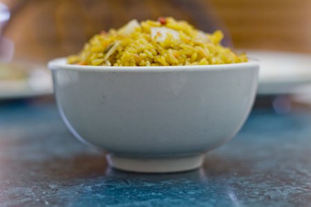 Selective focus on bowl of yellow Chinese pork fried riceの写真素材