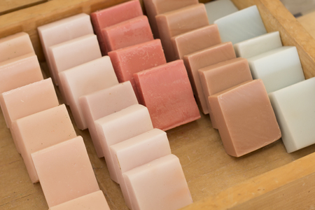 Rows of colorful homemade soap in display box