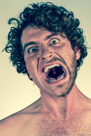 Half shaved bearded man with angry expressionの写真素材