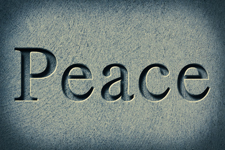 Engraving spelling the word Peace on textured old surfaceの写真素材