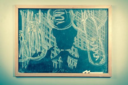 Silhouette of businessmanand lightbulbs drawn onto dirty school chalkboardの写真素材