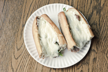 Philly Cheesesteak loaded with mozzarella cheese on submarine bunの写真素材