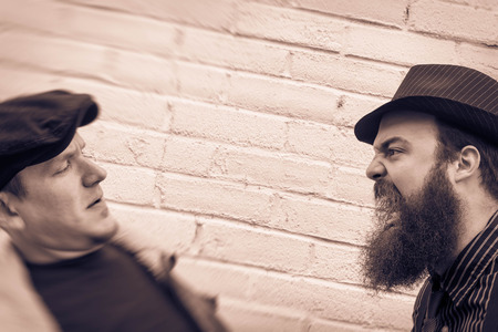 Crazy angry bearded man yells in the face of a passerbyの写真素材