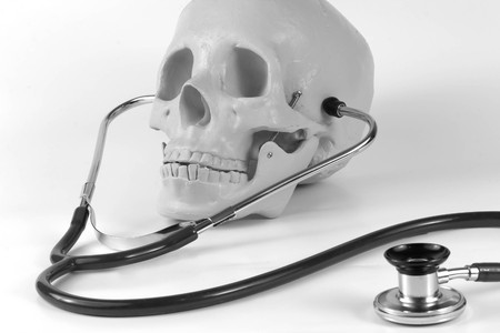 Educational medical supply skull wearing stethoscopeの写真素材