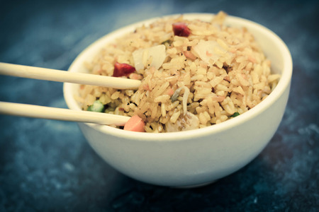 Selective focus on bowl of yellow Chinese pork fried riceの写真素材