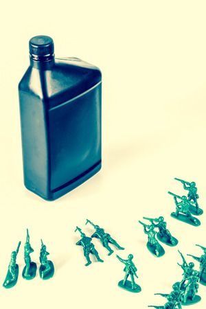 Toy army men with quart of oil symbolizing oil war in Middle Eastの写真素材