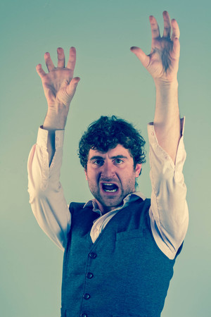 Man acting like an animal by growling snarling and clawingの写真素材