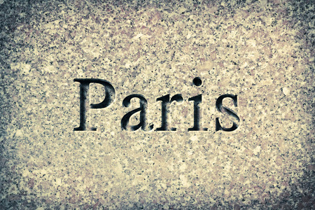 Engraving spelling the city Paris on textured old surfaceの写真素材