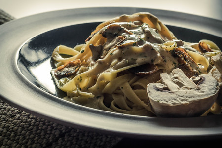 Fancy organic fetuccine pasta with creamy alfredo mushroom sauceの写真素材