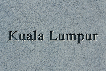 Engraving spelling the city Kuala Lumpur on textured old surfaceの写真素材