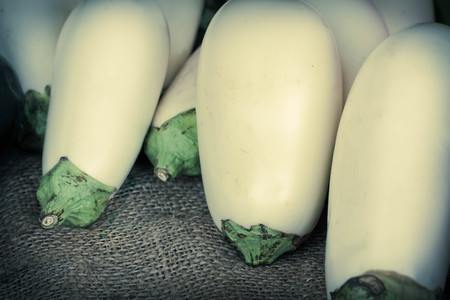 Organic white eggplant in a basket at the farmers marketの写真素材