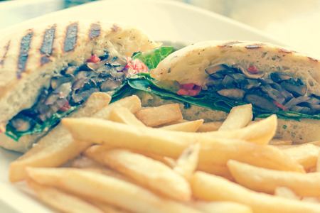 Portobello mushroom sandwich on a toasted ciabatta bun and side of friesの写真素材
