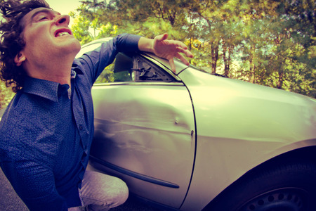 Silly man gets into car crash and makes ridiculous faceの写真素材
