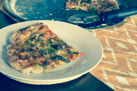 Home made artisan veggie pizza pie with onions peppers spinach and olivesの写真素材