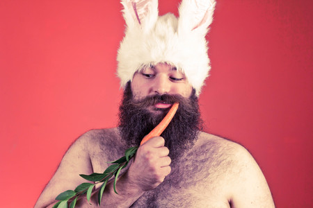 Childish bearded fat man wears silly bunny earsの写真素材