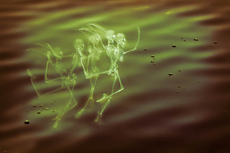 Scary dancing fairy skeletons on water backgroundの写真素材