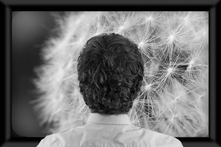 Back of man's head as he's watching flat screen televisionの写真素材