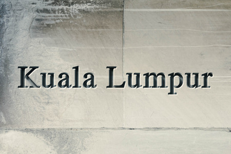 Engraving spelling the city Kuala Lumpur on textured old surfaceの写真素材