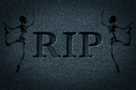 Engraved headstone spelling the letters RIP with Skeletons - rest in peaceの写真素材
