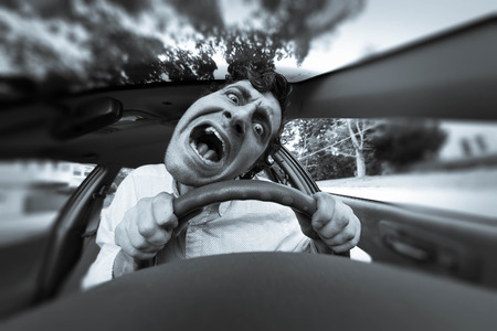 Silly man gets into car crash and makes ridiculous faceの写真素材