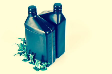 Toy army men with quart of oil symbolizing oil war in Middle Eastの写真素材