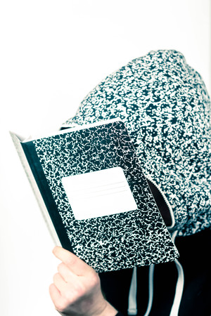 College student studies notes from marble notebook
