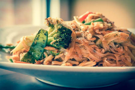 Authentic spicy Pad Thai with chicken served with Asian vegetablesの写真素材