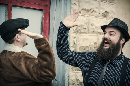 Fancy pals high five as they pass eachother