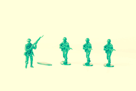Green army man steps off his foot stand for new adventureの写真素材