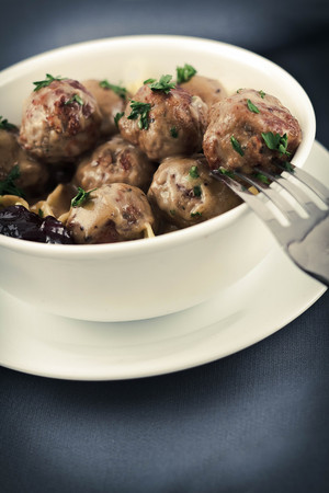 Swedish meatballs in creamy gravy with curly egg noodles and grape jellyの写真素材