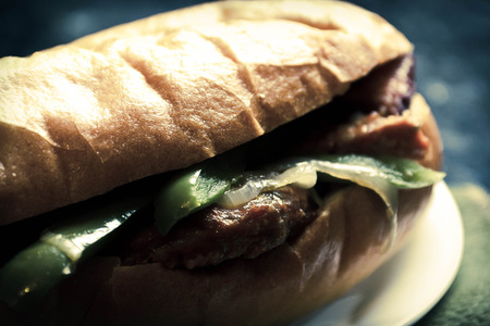 Fried sausage onions and green peppers on a torpedo rollの写真素材