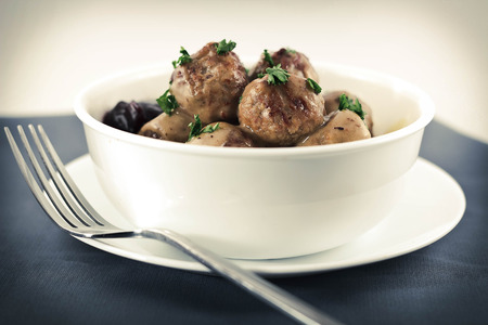 Swedish meatballs in creamy gravy with curly egg noodles and grape jellyの写真素材