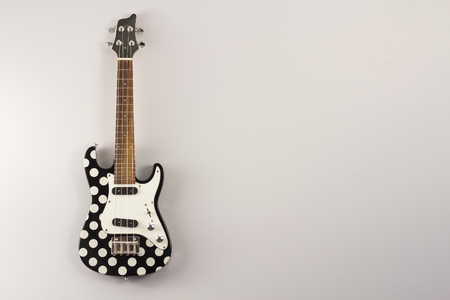 Hanging tenor electric ukulele with polka dotsの写真素材
