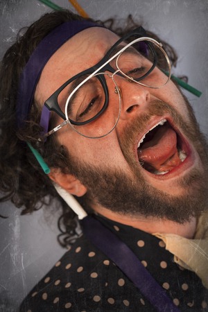 Bearded crazy person lunatic wearing several pairs of glassesの写真素材