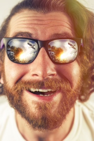 Bearded man vacation sunglasses reflection amazed expressionの写真素材