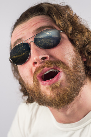 Bearded man mountain vacation sunglasses reflection amazed expressionの写真素材