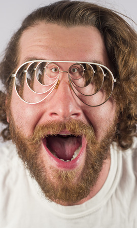 Silly surprised four eyed man wearing glassesの写真素材