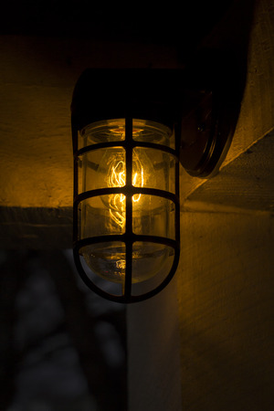 Decorative antique edison style filament light bulb outside at night